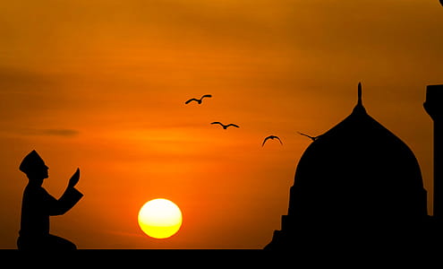 Silhouette of man praying with sunset background. thumbnail