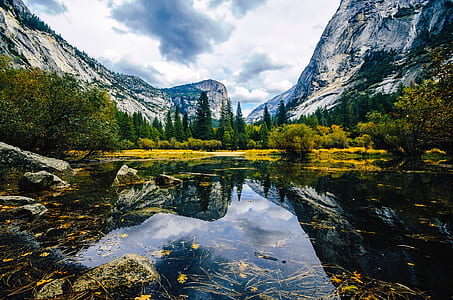 landscape photography of body of water near mountains thumbnail