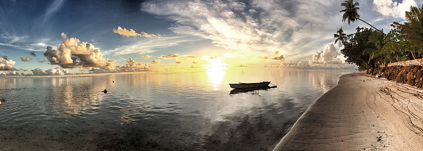 man's eyeview of rowboat near beach under cloudy skies during daytime thumbnail