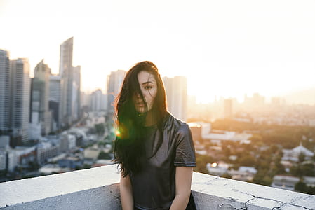 selective focus of woman standing beside wall thumbnail