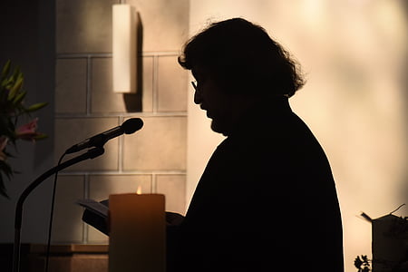 man reading a book in front of microphone thumbnail