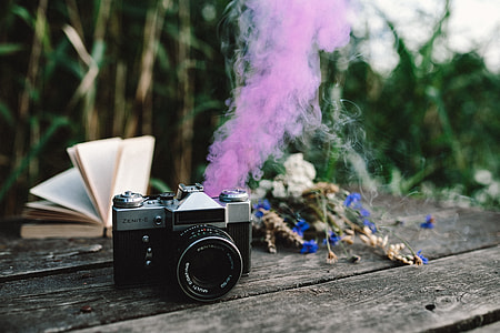 Colorful smoke bomb, book and vintage camera thumbnail