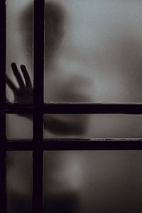 person placing hand on frosted door panel thumbnail