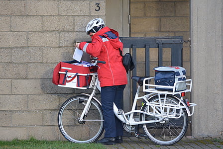 standing person beside white bicycle thumbnail