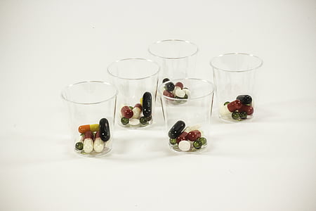 medication pills in five glass cups thumbnail