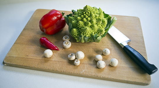 Romanesco broccoli, red chilly, red bell pepper, and black handled knife thumbnail