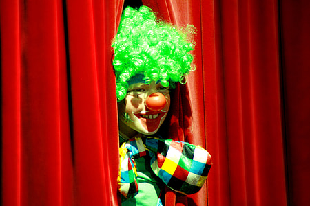 clown in between red curtain thumbnail