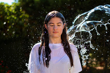 woman standing while being soaked in water thumbnail