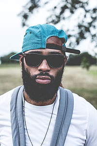 man wearing teal flat-brimmed cap thumbnail