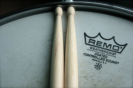 brown wooden precision drumsticks on Remo drum thumbnail