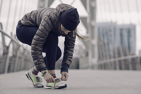 woman tying her shoe knot thumbnail