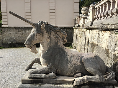 gray unicorn concrete statue under concrete balustrade at daytime thumbnail