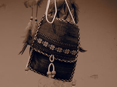 hanged brown and white floral handbag near wall thumbnail