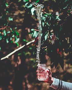 person holding clear glass jar thumbnail