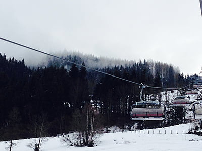 cable car over snow covered mountain thumbnail