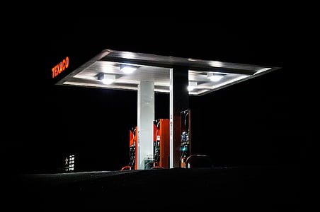 Texaco gasoline station with lights on at night time thumbnail
