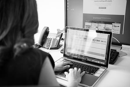 Grayscale Photo of Woman Using Macbook Pro thumbnail