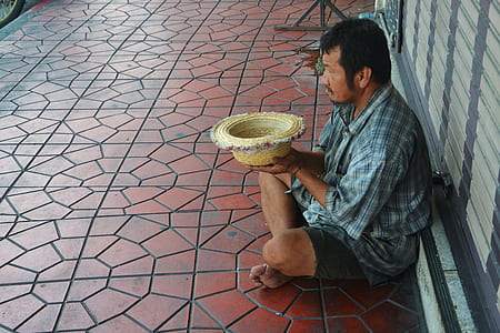 man sitting on brown ceramic tiles thumbnail