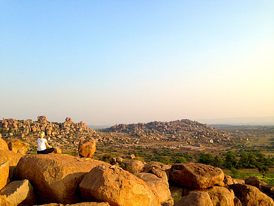 woman wearing white top while sitting on the concrete stone thumbnail