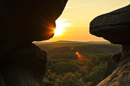 silhouette of rock formation near trees thumbnail