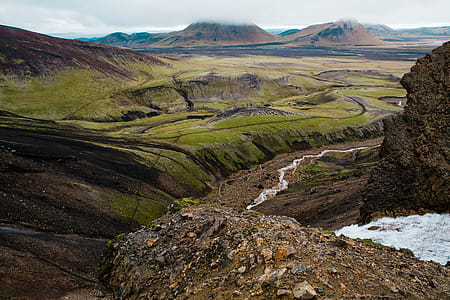 Glacier water winding through rocky landscape of a mountain in Iceland thumbnail