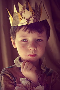 boy in brown collared ruffled top with crown portrait photo thumbnail