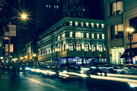 vehicles near buildings and post lamps thumbnail