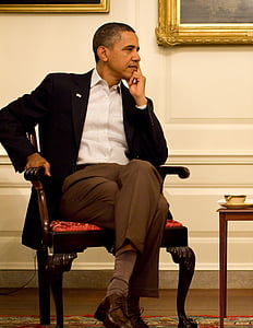 Barack Obama sitting on brown wooden armchair thumbnail