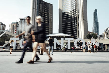 group of people standing in-front of gray mid-rise building thumbnail