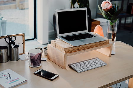 silver MacBook on brown table thumbnail