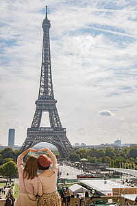 Photo of Two Women Posing in Front of Eiffel Tower, Paris, France during Day Time thumbnail