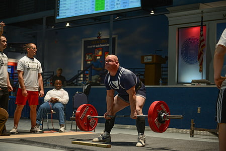 man lifting red barbell in gym thumbnail