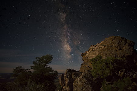 brown rock formation under starry sky thumbnail