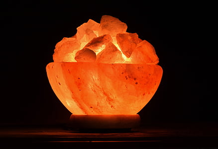 lighted Himalayan salt lamp on brown surface thumbnail