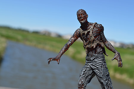 selective focus photography of male zombie figurine under clear blue sky thumbnail