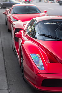 two red sports cars on asphalt road way thumbnail