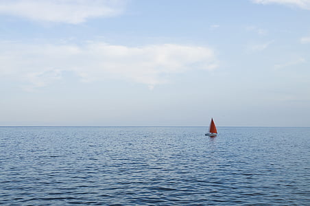 red sailboat sailing on sea at daytime thumbnail