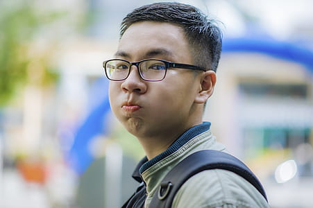 Man Wearing Gray Jacket and Black Framed Eyeglasses thumbnail