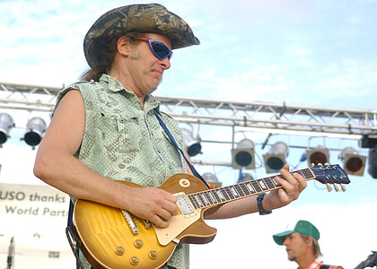 man playing the electric guitar on stage thumbnail