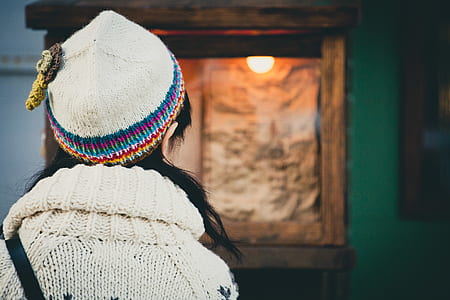 woman standing in front of brown wooden rack thumbnail