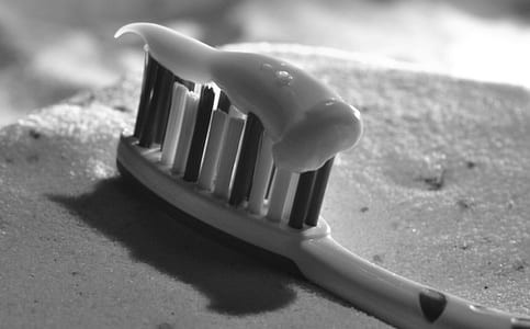 grayscale photo of toothbrush with toothpaste thumbnail