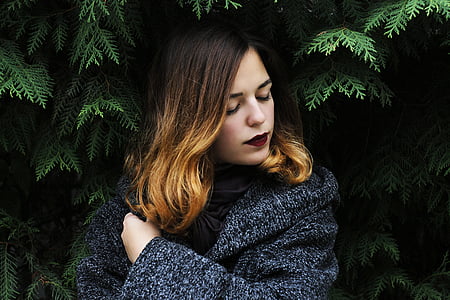 woman in gray top standing beside plants thumbnail