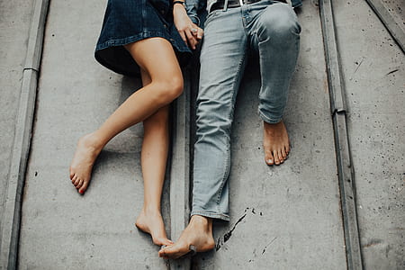 photo of woman and man laying on floor and holding hands thumbnail