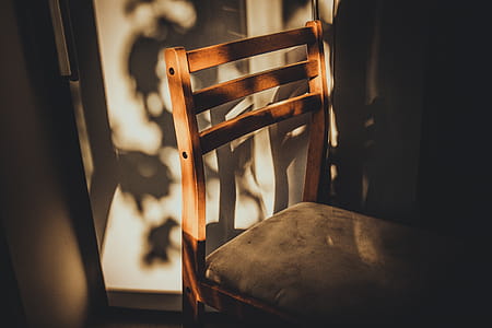 Brown Wooden Chair Beside White Painted Wall thumbnail