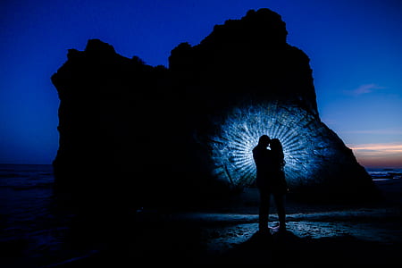 silhouette of couple near rock formation thumbnail