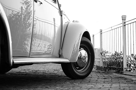 White Volkswagen Beetle Near White Metal Fence thumbnail