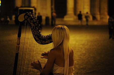 woman in white dress playing harp thumbnail