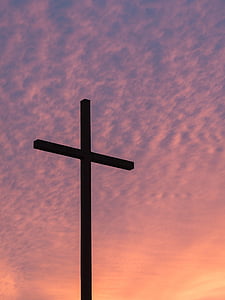 silhouette of cross under white sky thumbnail