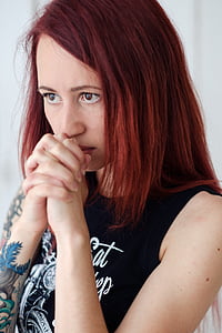 woman with holdings hands wearing black tank top during daytime thumbnail
