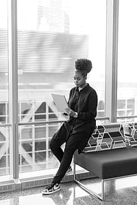 Woman Sitting on Sofa Looking at Book thumbnail